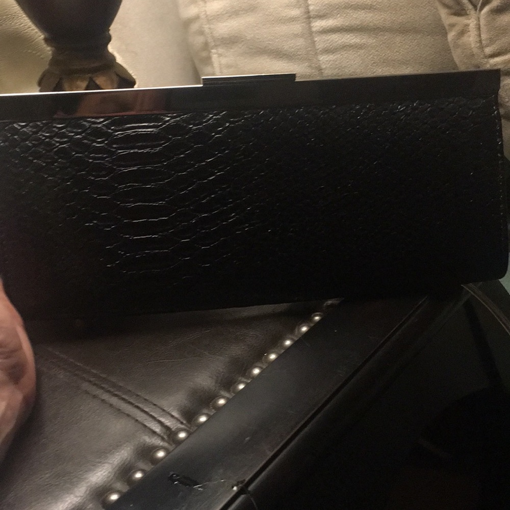 Sleek black clutch with silver chain